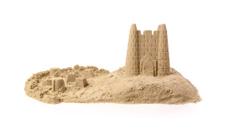 Pile of sand with beautiful castle on white background