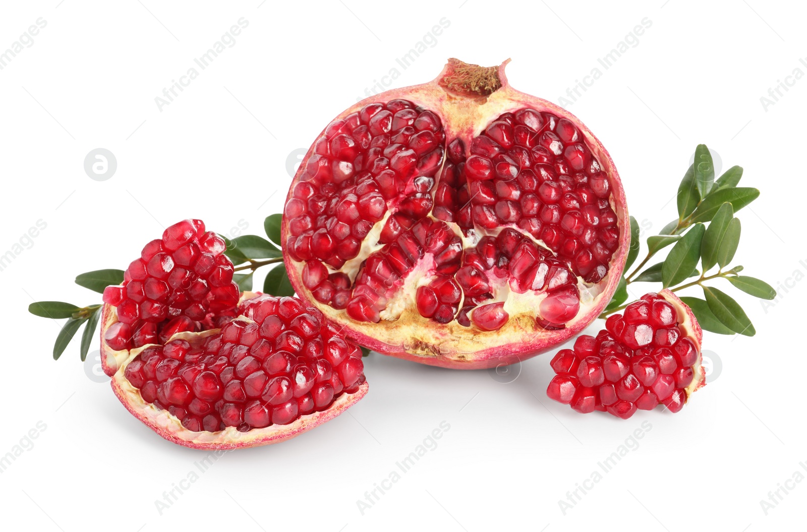 Photo of Fresh cut pomegranate and branches isolated on white