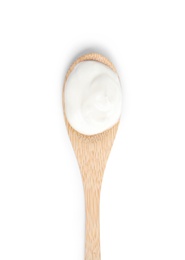 Photo of Wooden spoon with sour cream on white background, top view