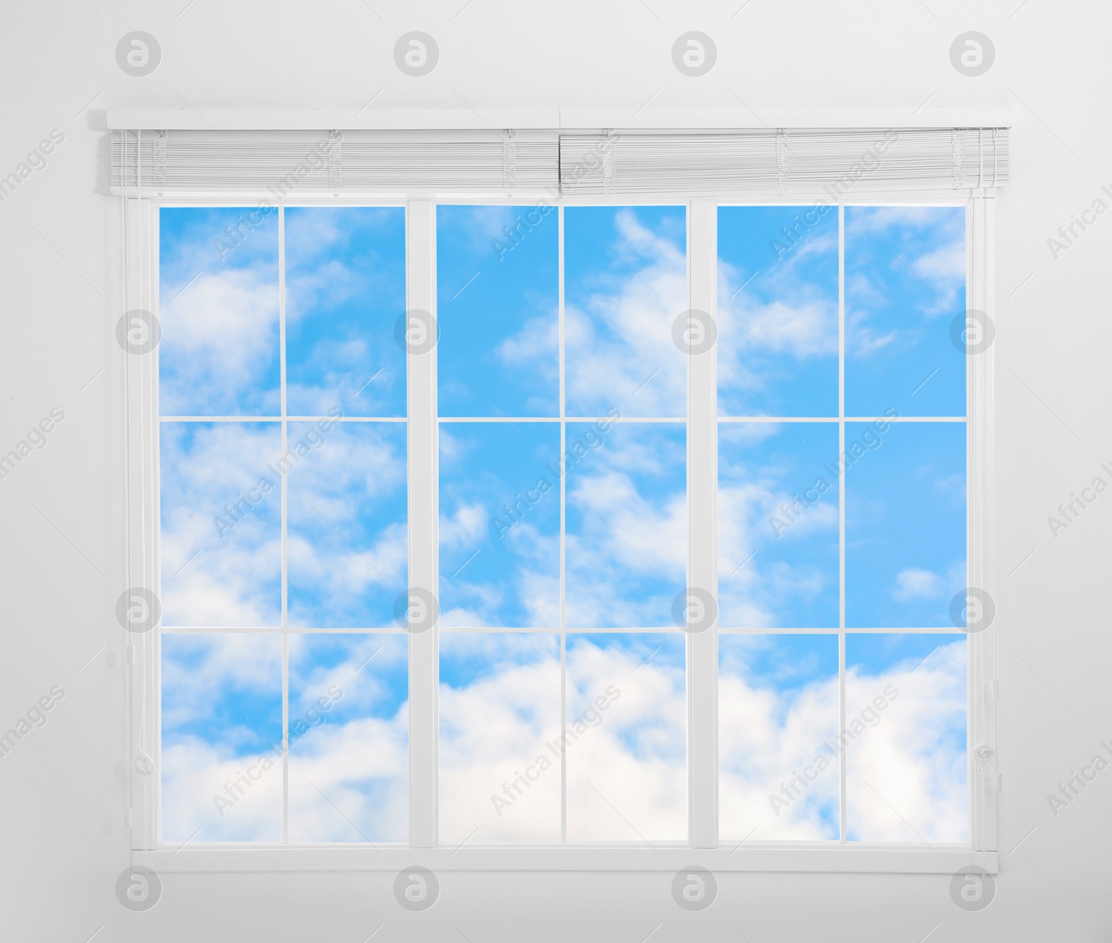 Image of Beautiful view on blue sky with clouds through window