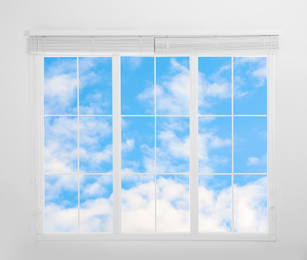 Image of Beautiful view on blue sky with clouds through window