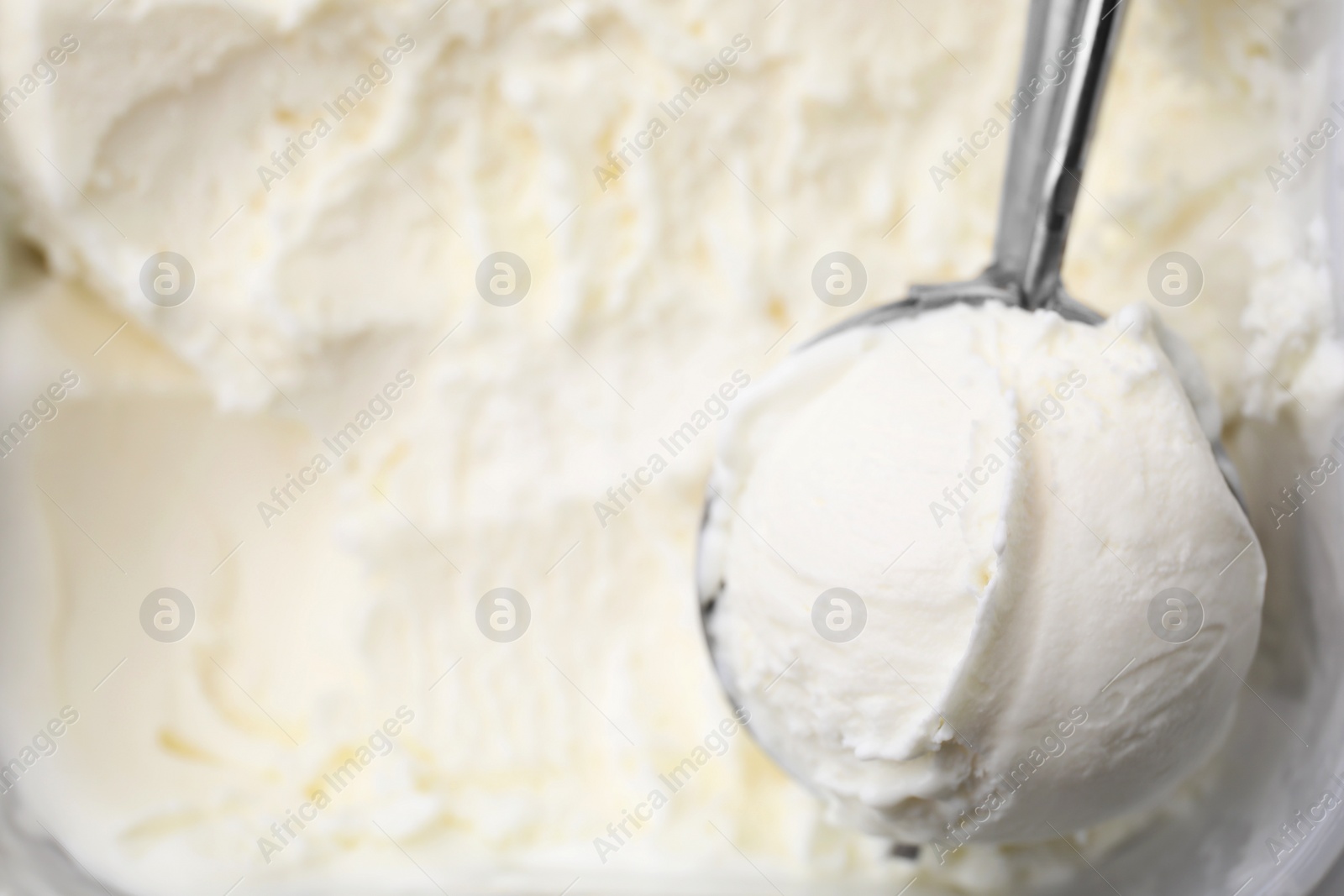 Photo of Steel scoop with tasty vanilla ice cream, top view Space for text