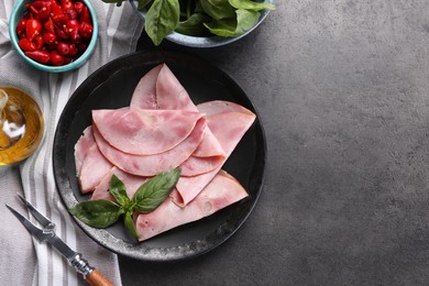 Photo of Tasty ham with basil and pickled peppers served on grey table, flat lay. Space for text