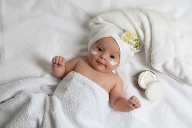 Photo of Cute little baby with cream on face, top view