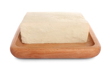 Photo of Wooden plate with delicious raw tofu isolated on white