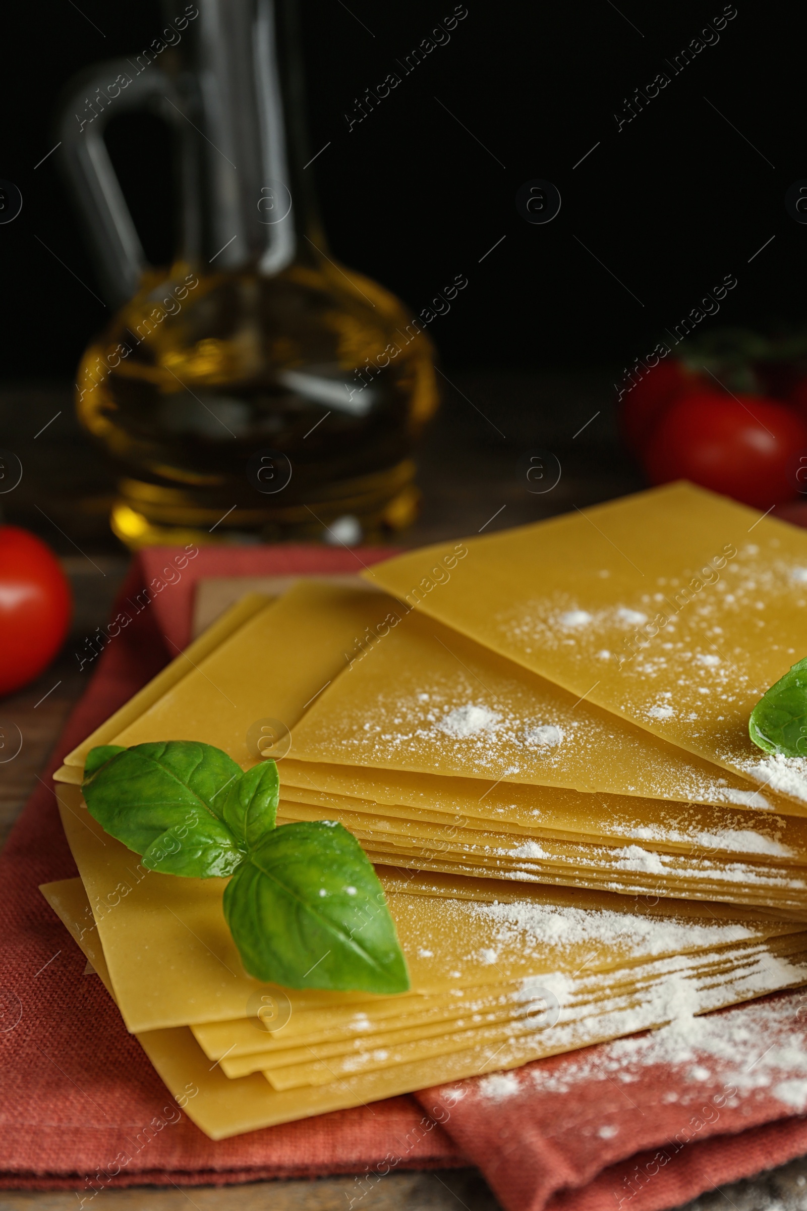 Photo of Composition with uncooked lasagna sheets on wooden table