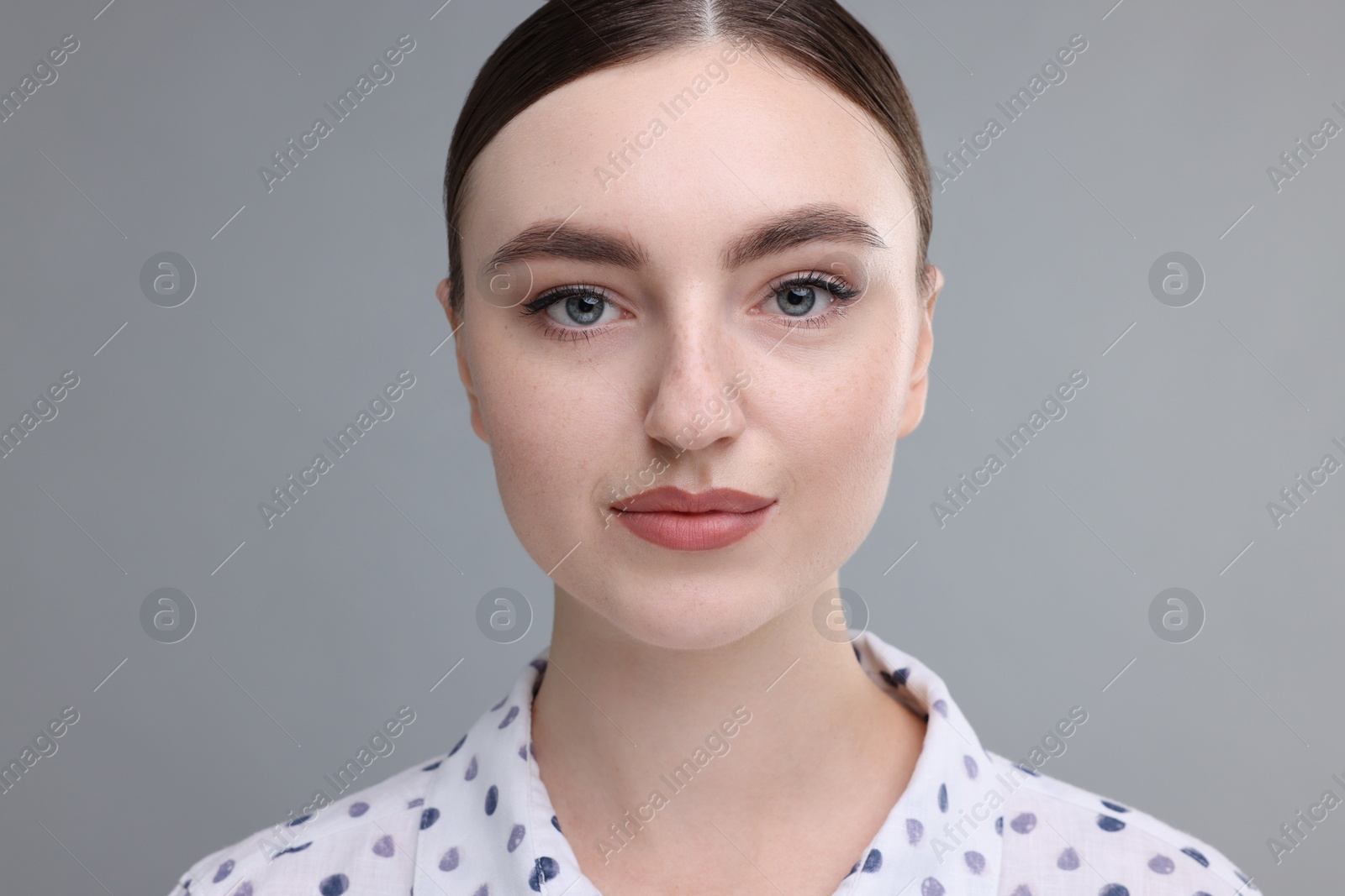 Photo of Portrait of beautiful woman on grey background