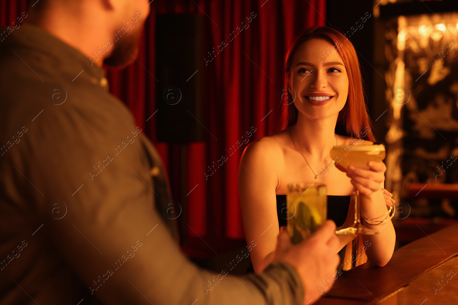 Photo of Couple with fresh cocktails at bar counter