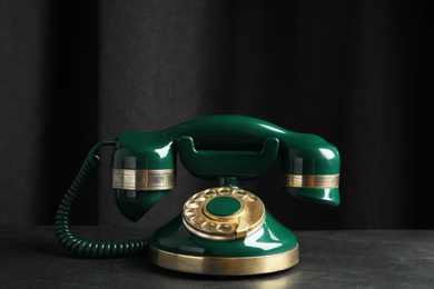Photo of Vintage corded phone on black stone table