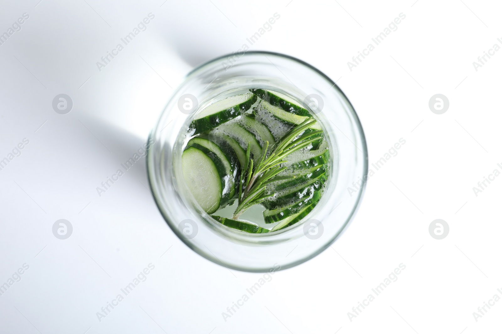 Photo of Glass of fresh cucumber water on white background, top view