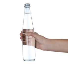 Woman holding glass bottle with water on white background, closeup