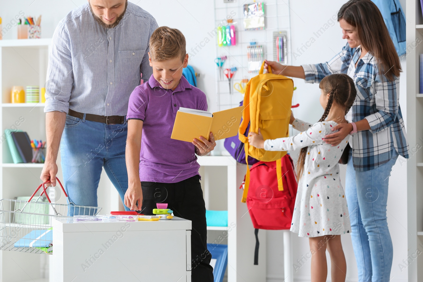 Photo of Children with parents choosing school stationery in store