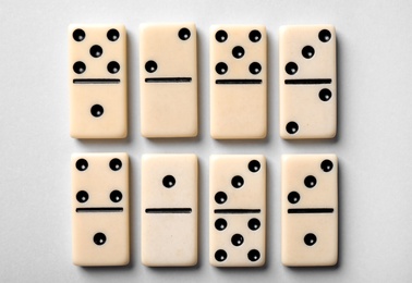 Photo of Set of classic domino tiles on white background, top view