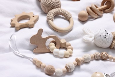 Many different baby accessories on white fabric