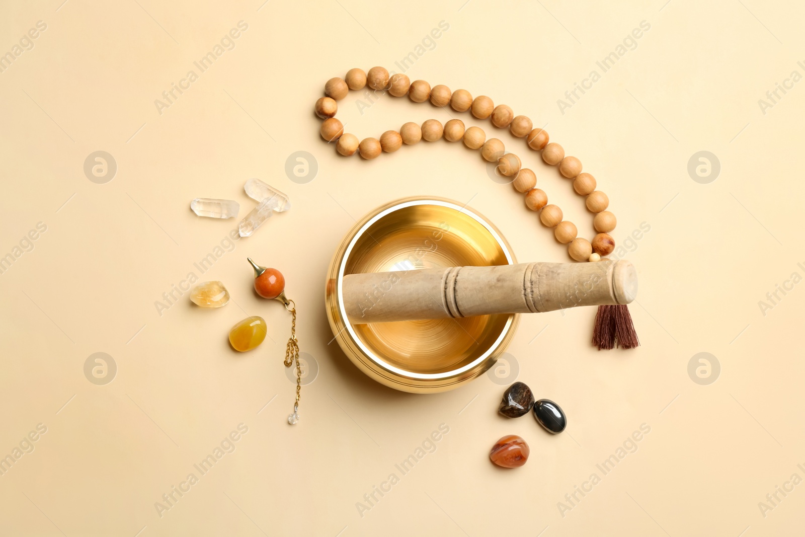 Photo of Flat lay composition with golden singing bowl on beige background. Sound healing
