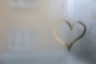 Photo of Heart drawn on foggy window, space for text. Rainy weather