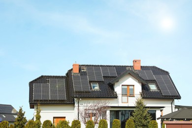 House with installed solar panels on roof. Alternative energy