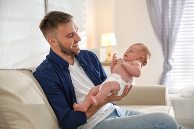 Father with his newborn son at home