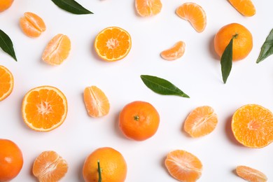 Photo of Composition with fresh ripe tangerines and leaves on white background, flat lay. Citrus fruit