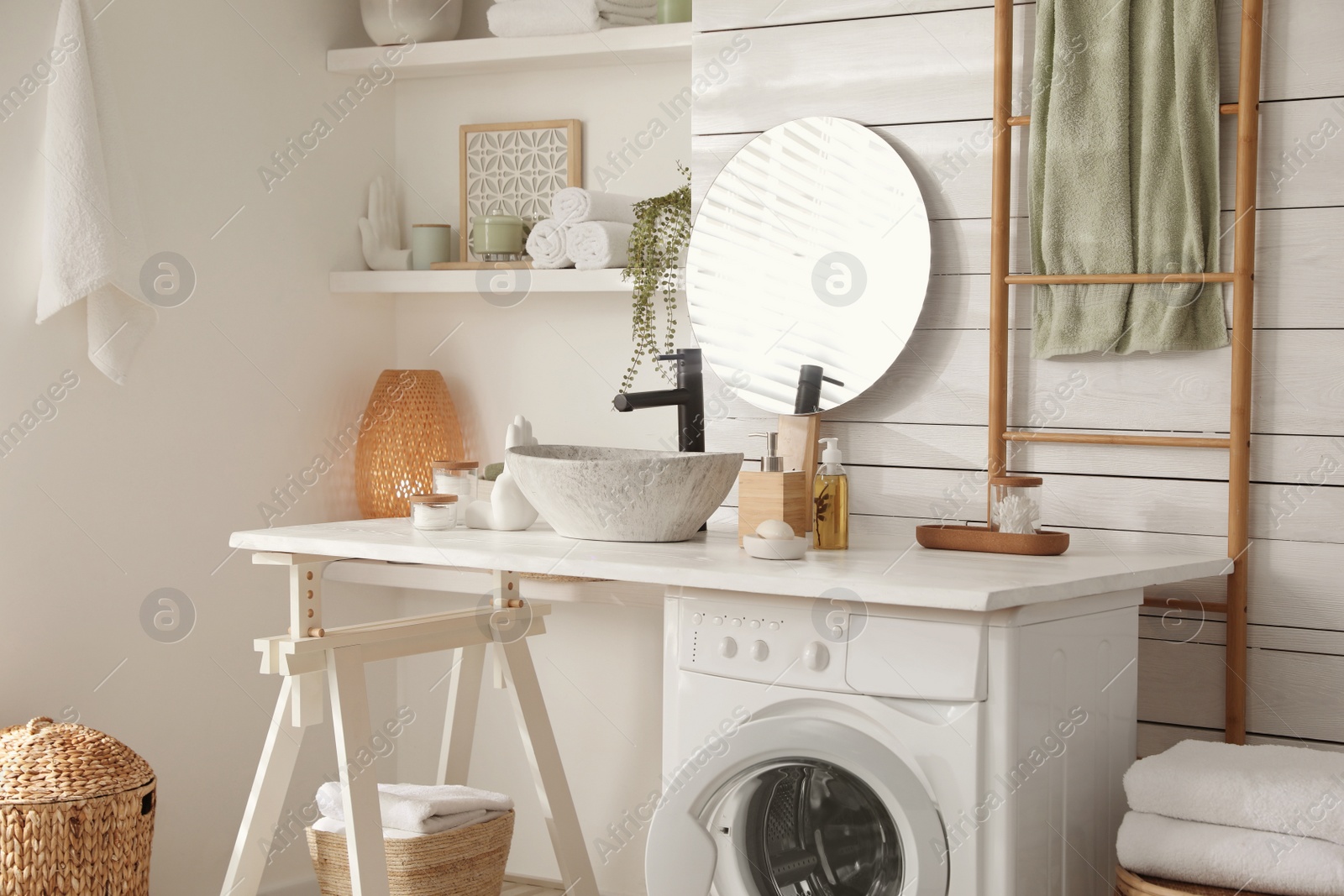 Photo of Stylish bathroom interior with modern washing machine