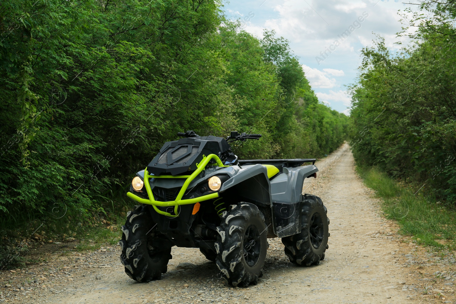 Photo of Modern quad bike on pathway near trees outdoors