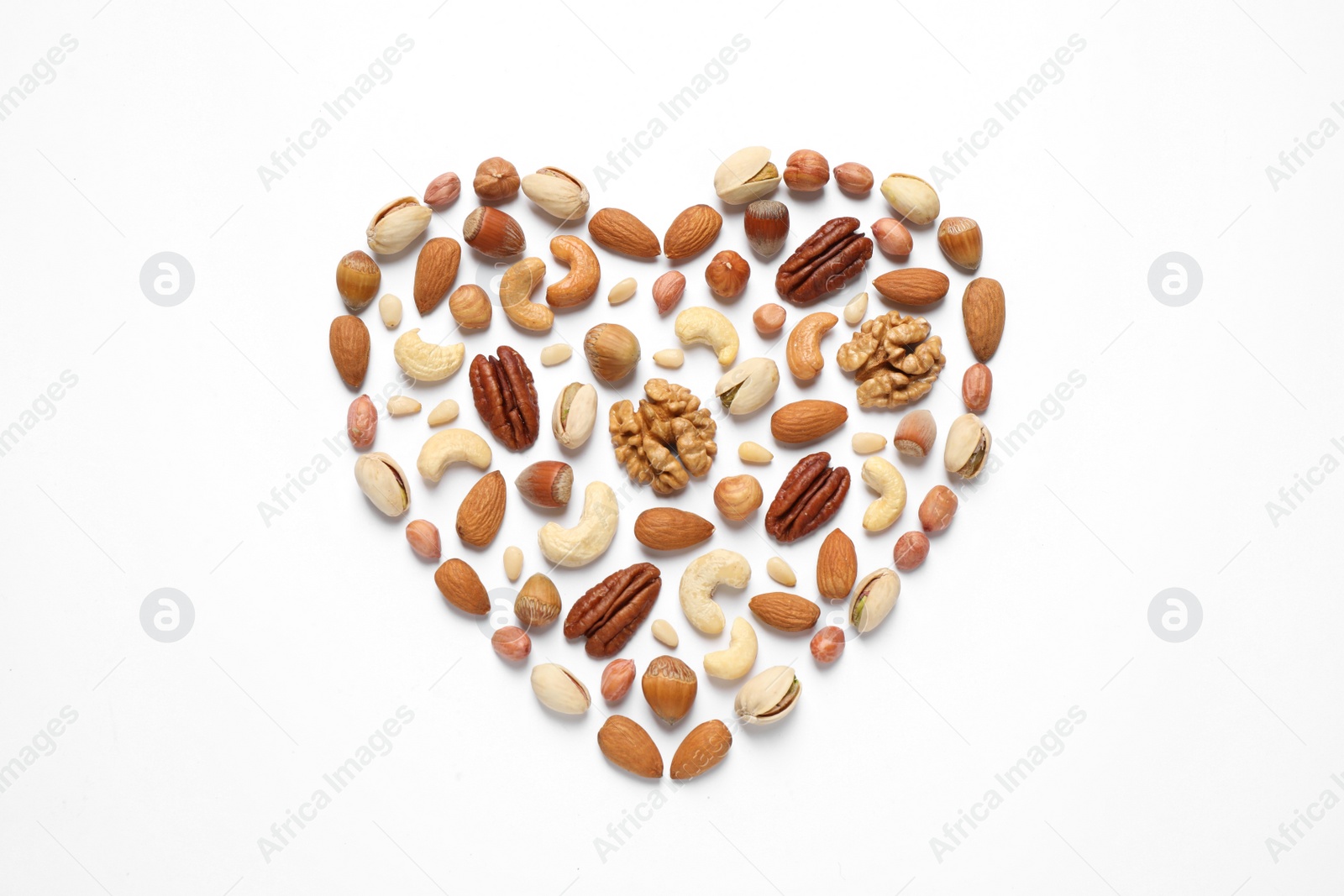 Photo of Heart made of different nuts on white background, flat lay