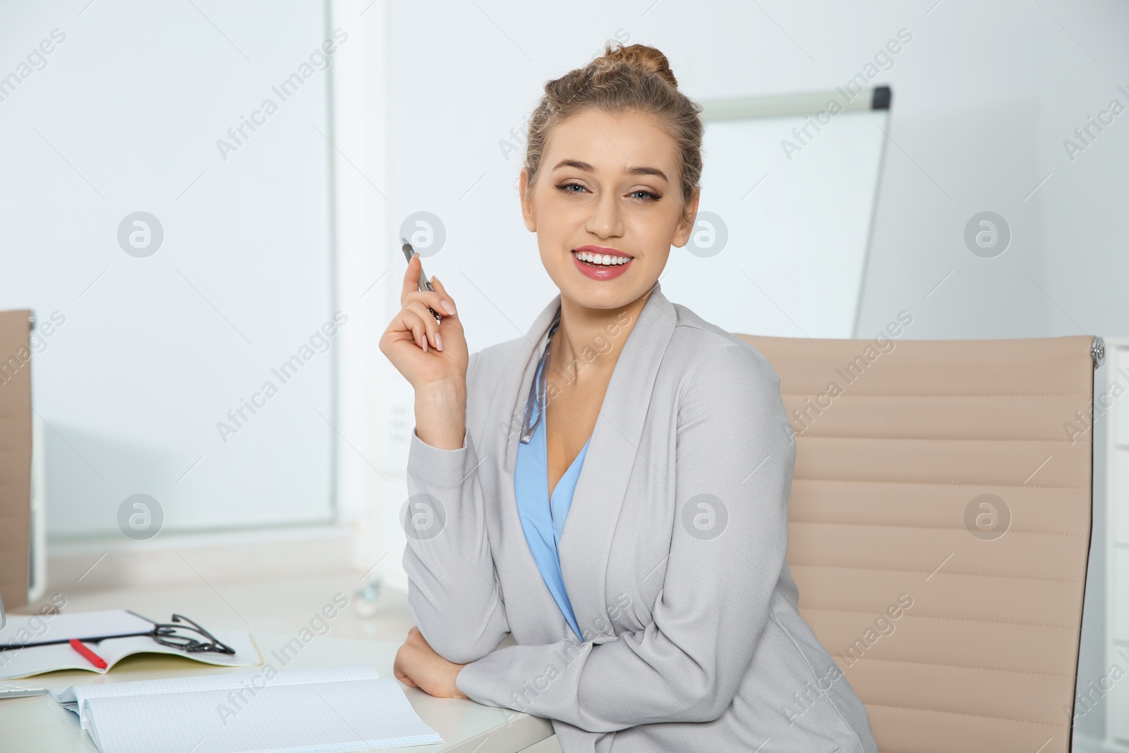 Photo of Portrait of young businesswoman laughing at workplace