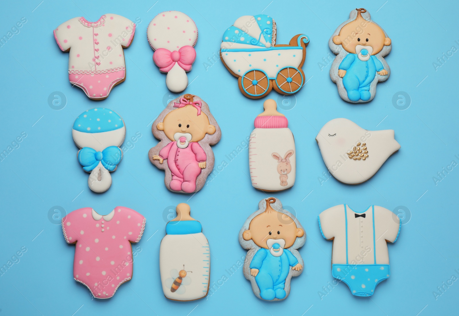 Photo of Set of baby shower cookies on turquoise background, flat lay