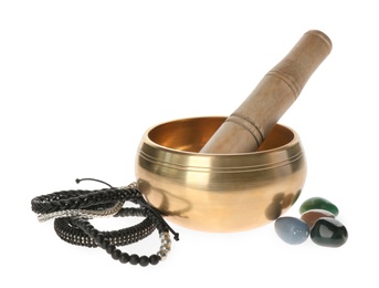 Photo of Golden singing bowl with mallet, healing stones and bracelets on white background