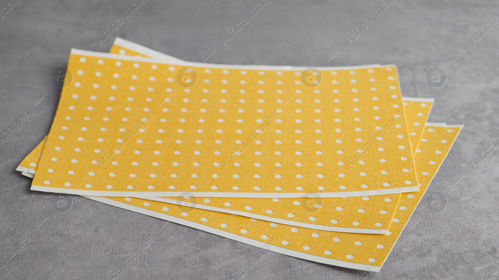 Photo of Pepper plasters on grey textured background, closeup