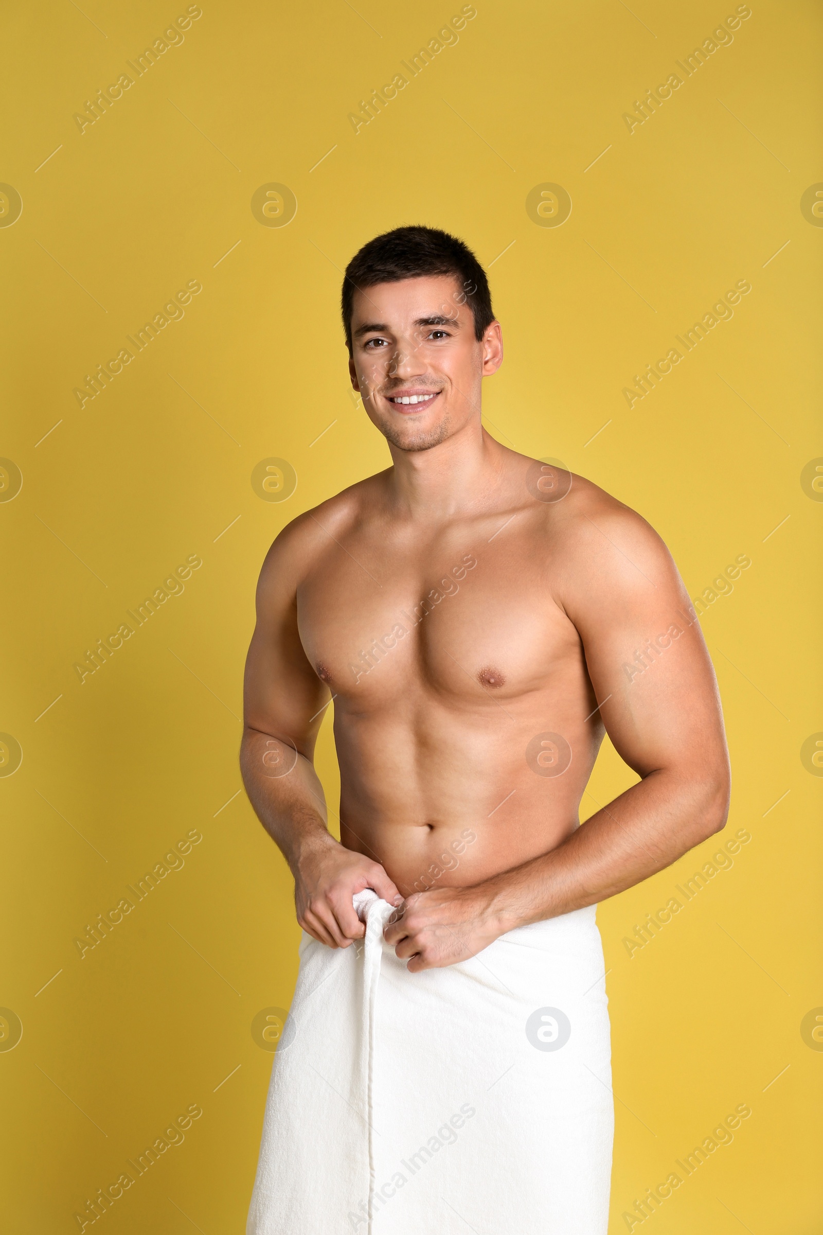 Photo of Man with sexy body on yellow background