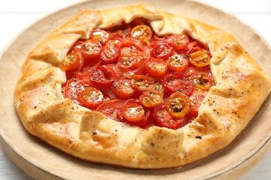 Photo of Tasty tomato galette (Caprese galette) on table, closeup