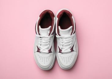 Photo of Pair of stylish shoes on pink background, top view