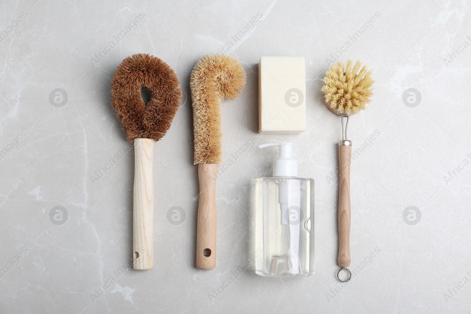 Photo of Flat lay composition with cleaning supplies for dish washing on grey table, flat lay