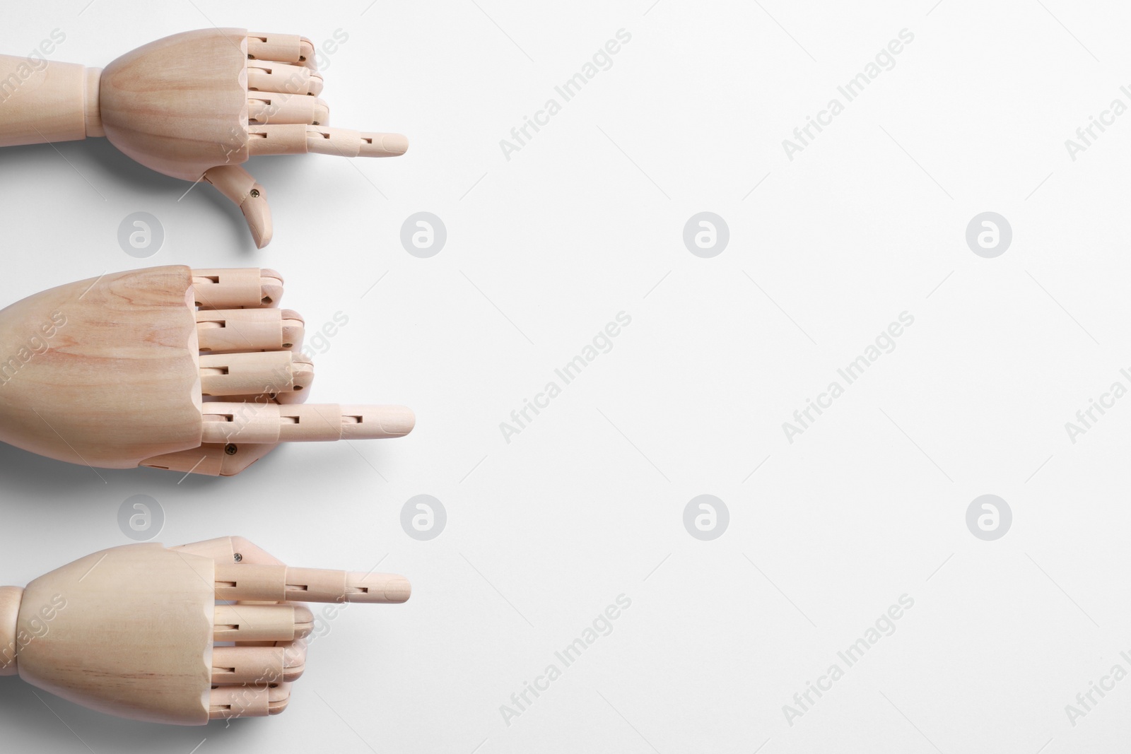 Photo of Wooden mannequin hands on white background, flat lay