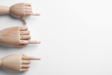 Wooden mannequin hands on white background, flat lay