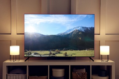 Image of Amazing mountain landscape on TV screen in room