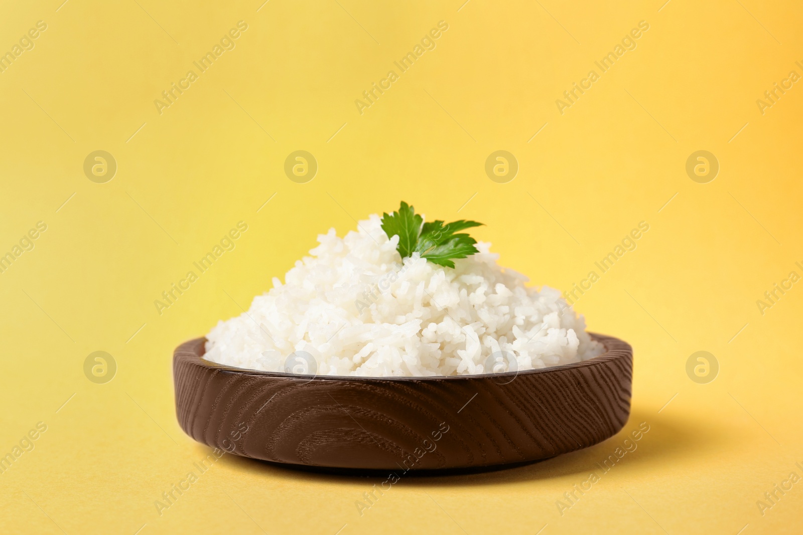 Photo of Bowl of boiled rice on color background