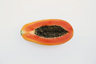 Photo of Half of fresh ripe papaya fruit on white background, top view