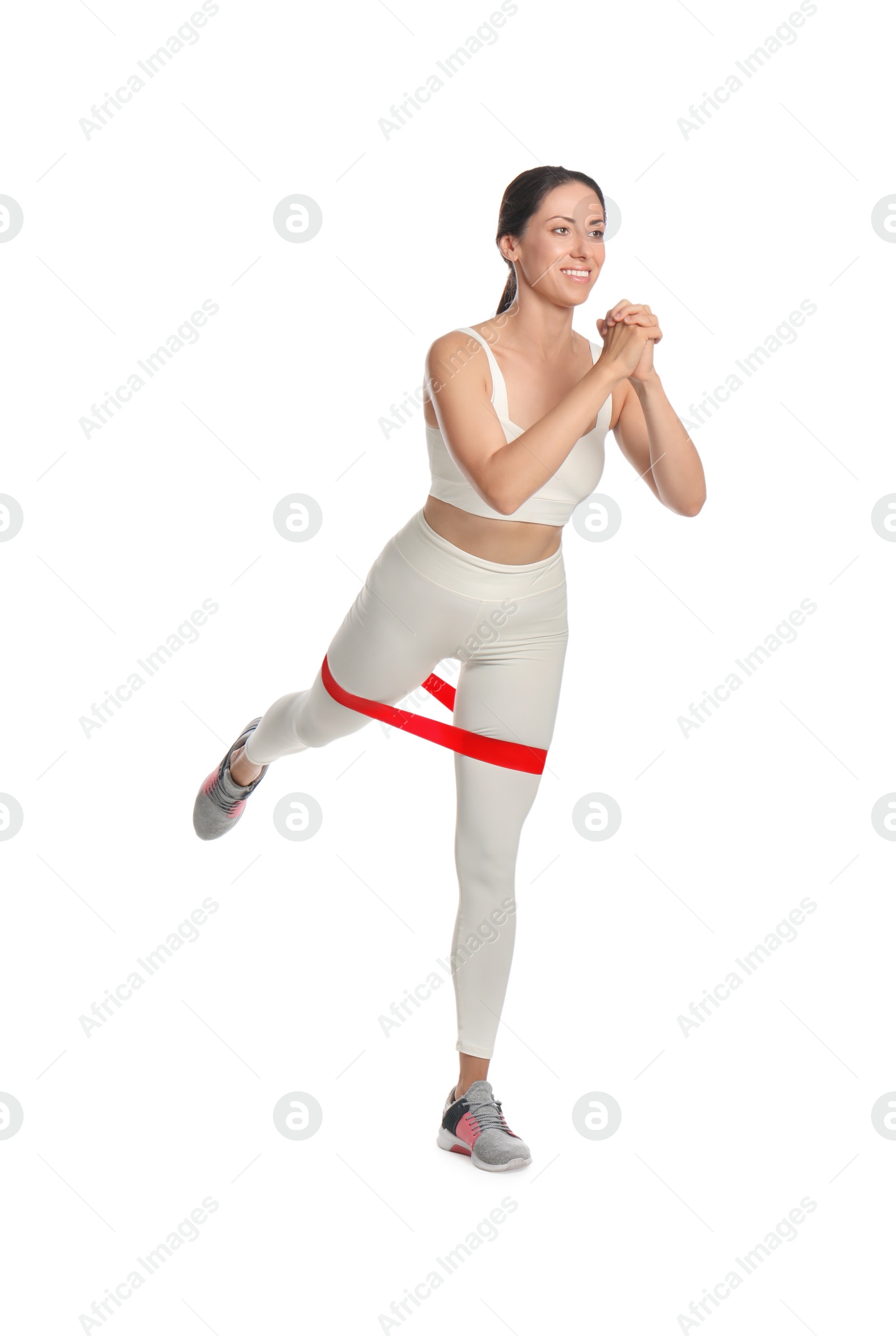 Photo of Woman doing sportive exercise with fitness elastic band on white background