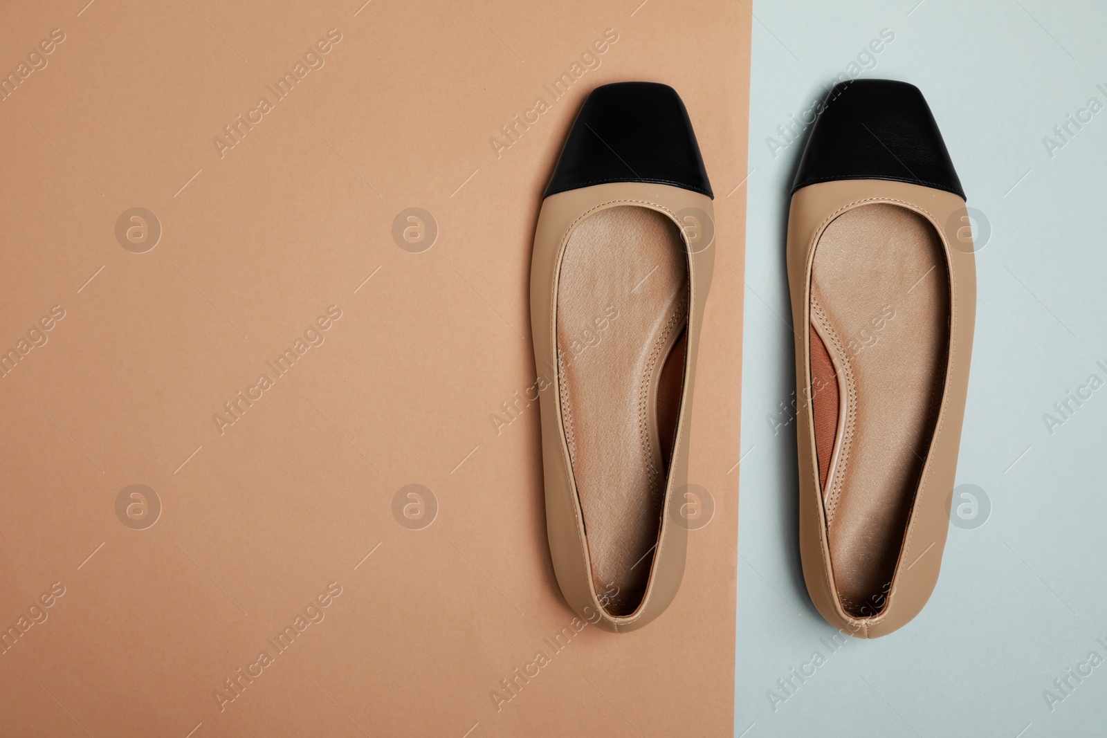 Photo of Pair of new stylish square toe ballet flats on colorful background, flat lay. Space for text