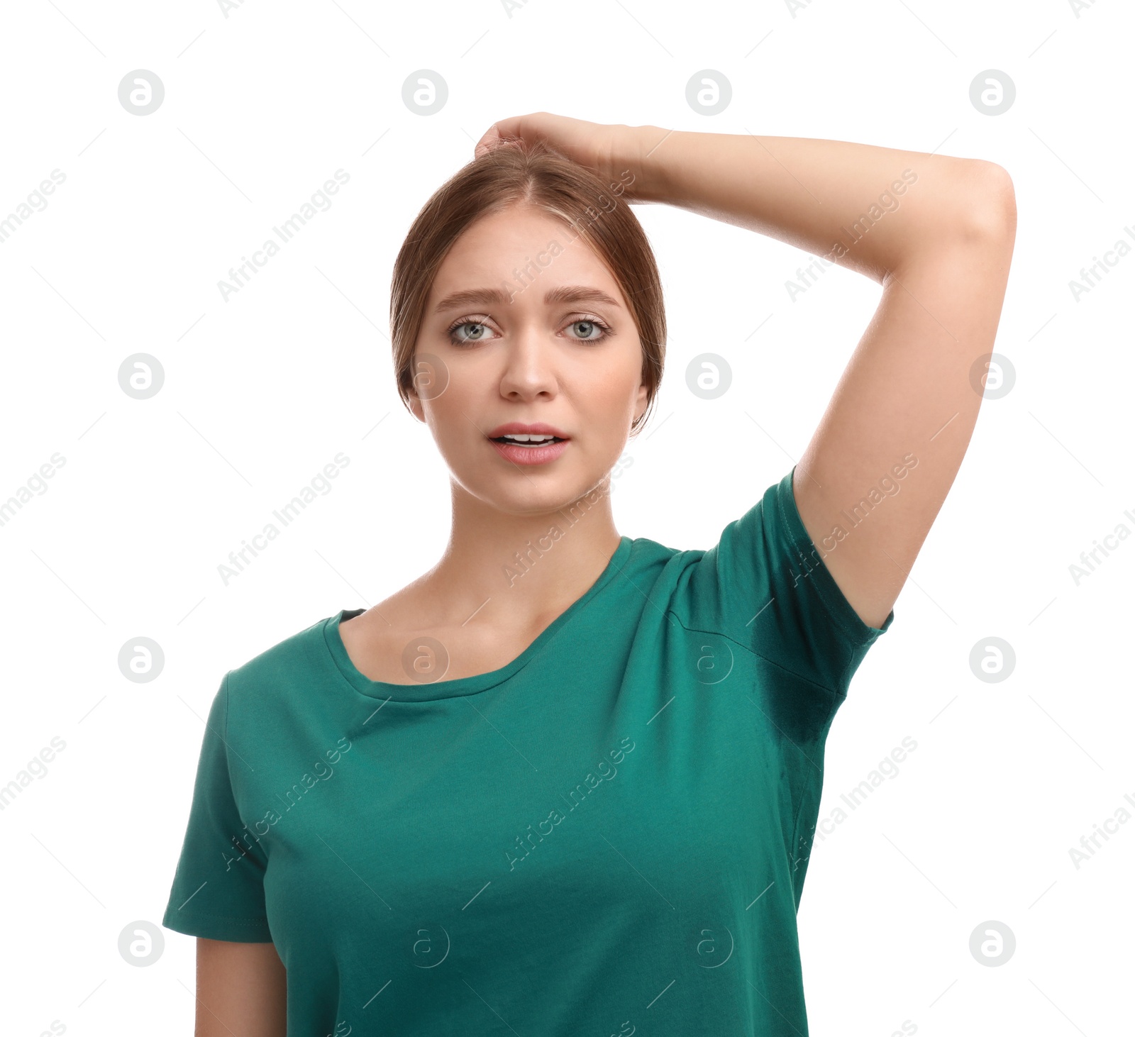 Photo of Young woman with sweat stain on her clothes against white background. Using deodorant