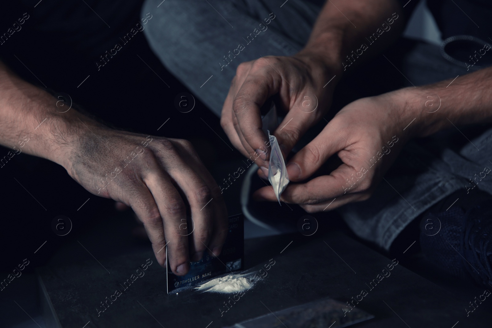 Photo of Young addicted men taking drugs, closeup of hands