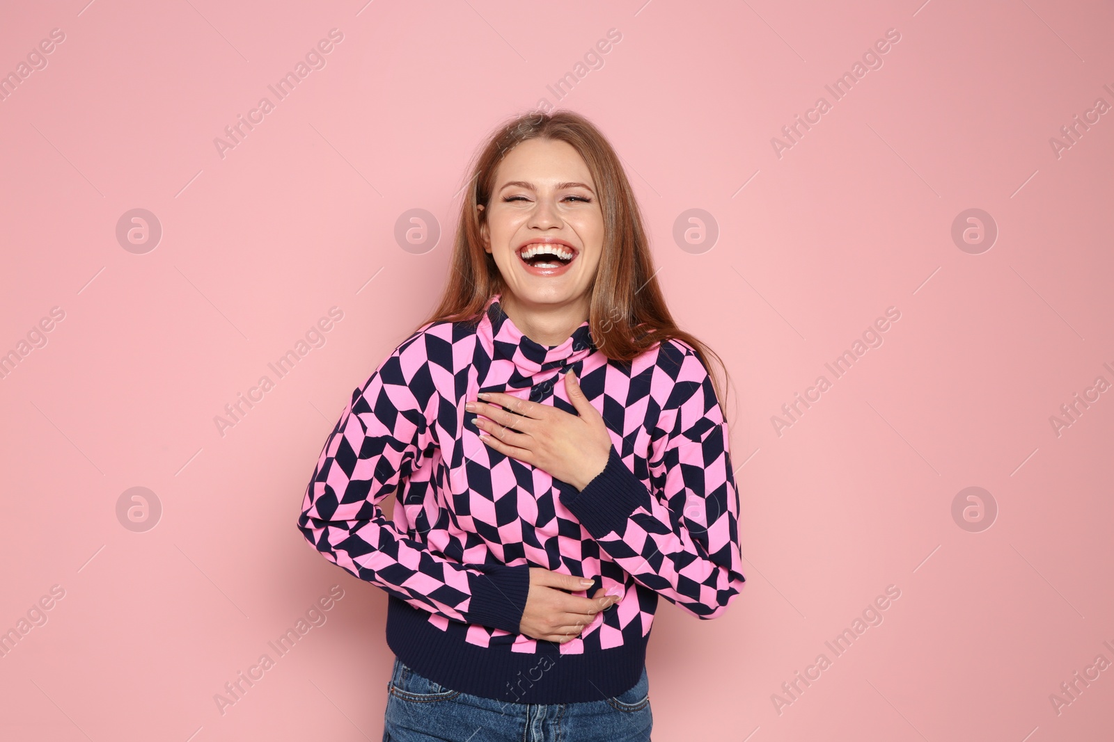 Photo of Portrait of young woman laughing on color background