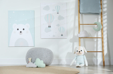 Photo of Baby room interior with toys and cute posters on wall