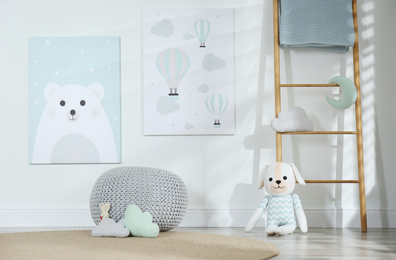 Baby room interior with toys and cute posters on wall