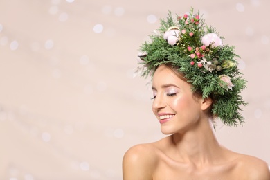 Photo of Happy young woman wearing wreath against blurred lights. Space for text