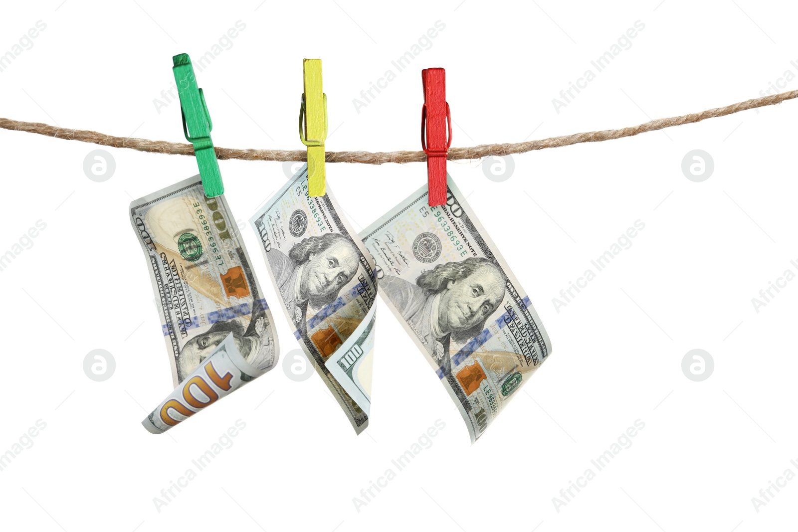 Image of Money laundering. Dollar banknotes hanging on clothesline against white background