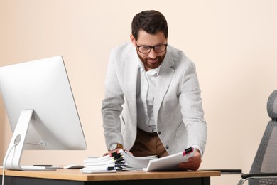 Photo of Happy businessman working with documents in modern office