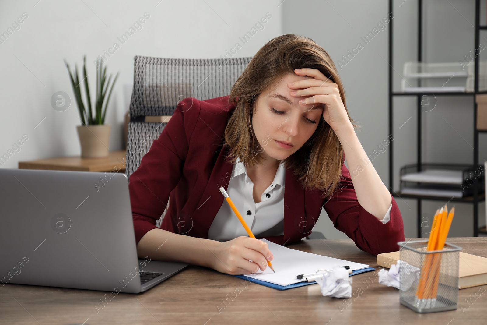 Photo of Sad businesswoman working at wooden table in office